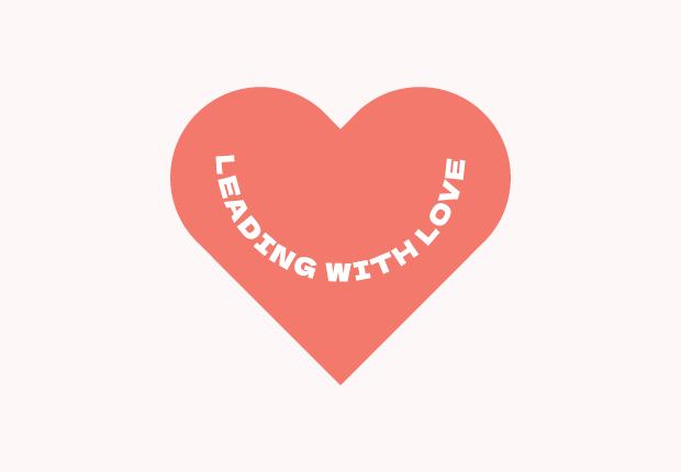 "Leading With Love" text in a half circle inside a coral red heart.